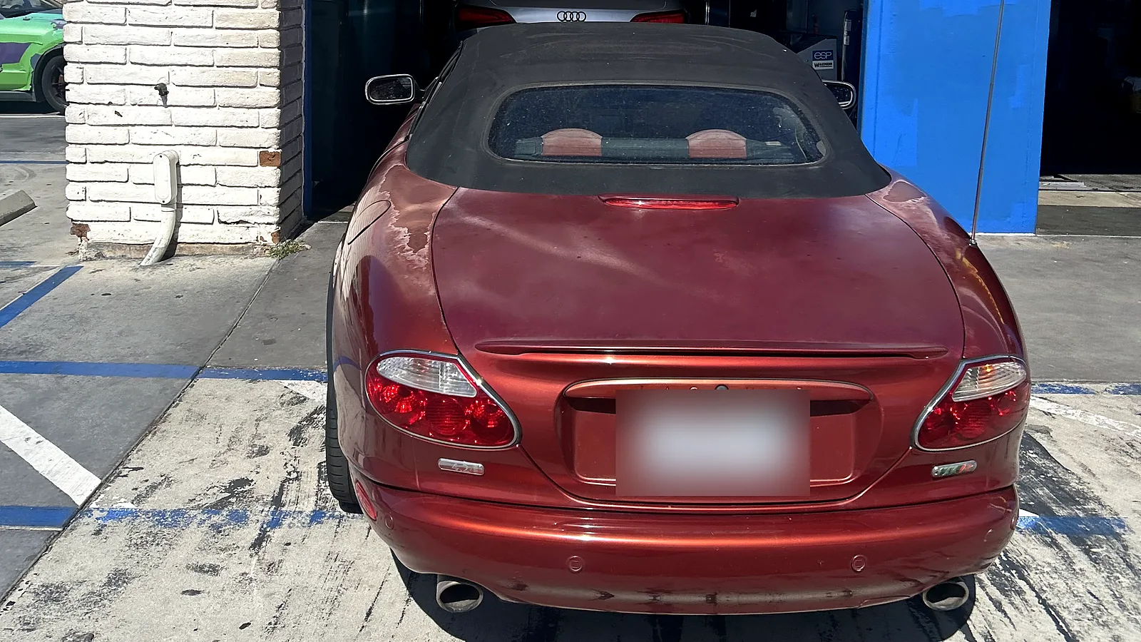 Clutch and manual transmission repair in Encinitas, CA: red Jaguar XK convertible at our service bay