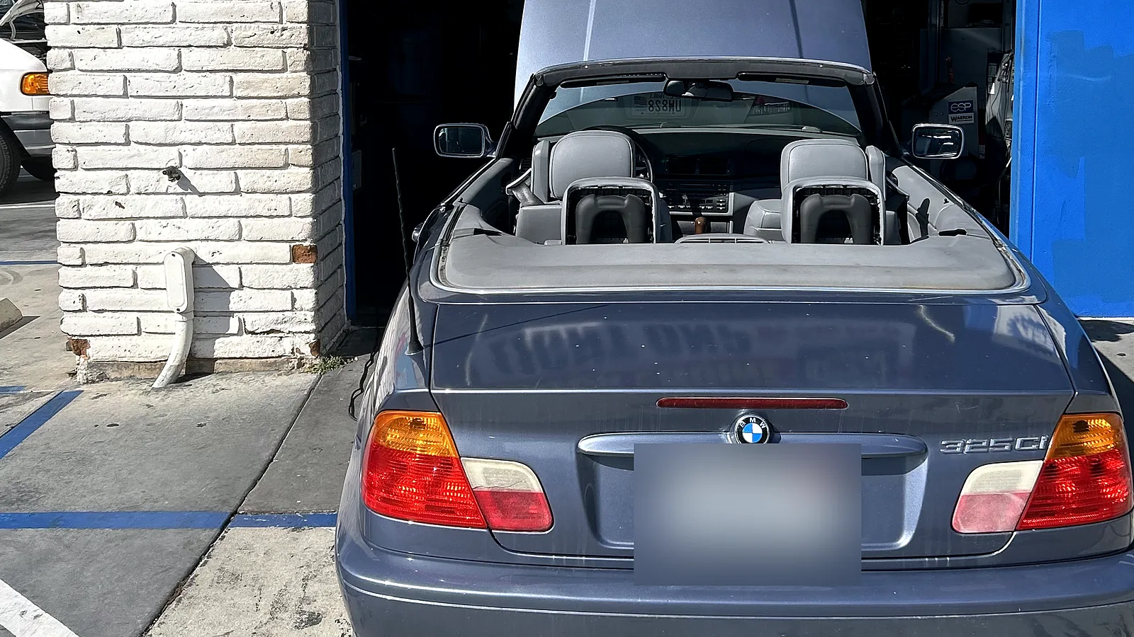 Failed smog check help in Encinitas, CA: BMW convertible with the hood up at our bay
