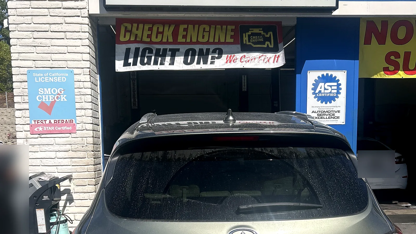 STAR smog check in Encinitas, CA: Infiniti QX60 pulled up to our service bay under the Smog / Auto Repair sign